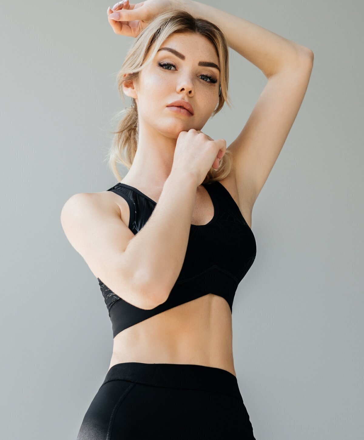 Phoenix liposuction model wearing a black top